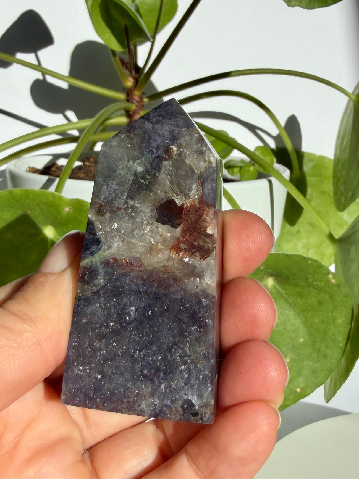 Sunstone in iolite point with a natural crack running down through the upper stone and concentrated sparkle near the base