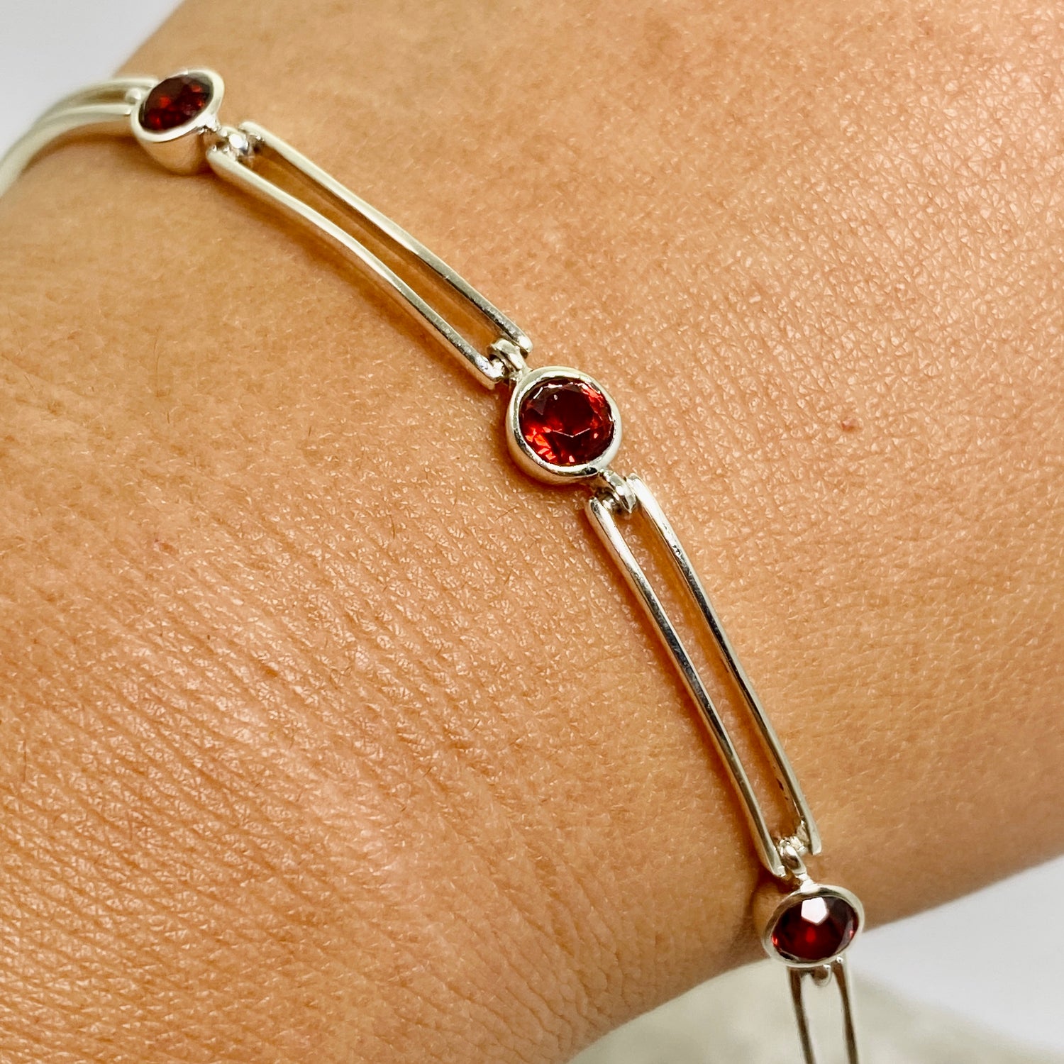 Garnet round faceted gemstones with silver split spacer design