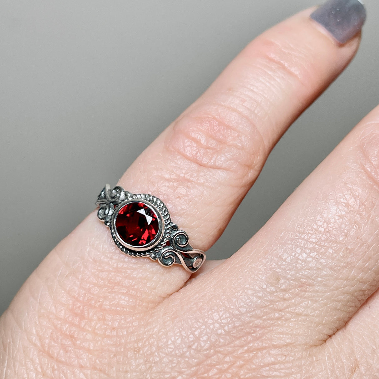 Garnet Round Faceted Ring in a Decorative Setting R4170