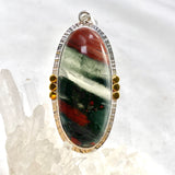 Bloodstone Oval Cabochon Pendant in a Decorative Setting with Brass Accents KPGJ4745