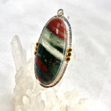 Bloodstone Oval Cabochon Pendant in a Decorative Setting with Brass Accents KPGJ4745