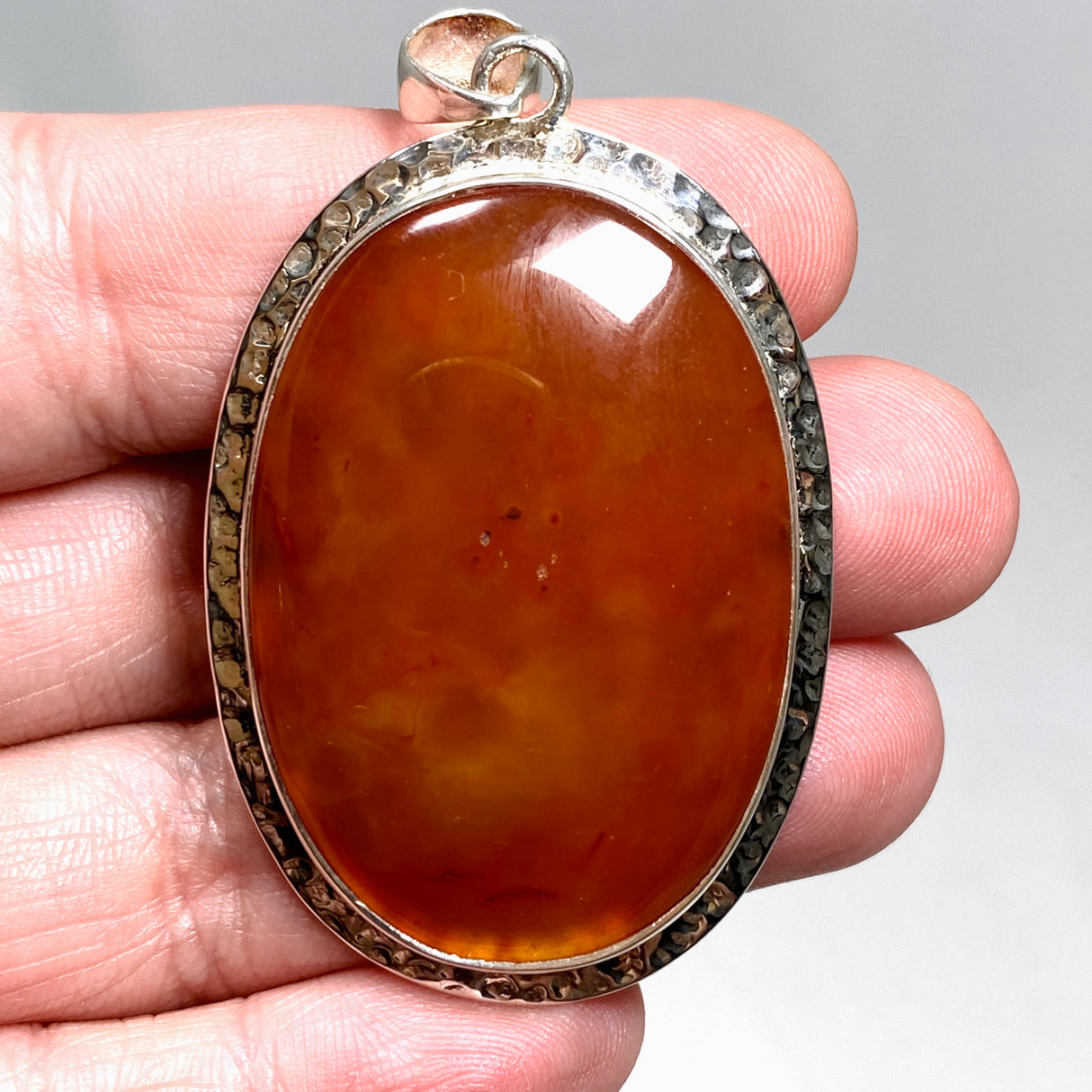 Carnelian Oval pendant in a decorative hammered setting KPGJ4579