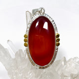 Carnelian Oval pendant with a brass decorative setting KPGJ4581