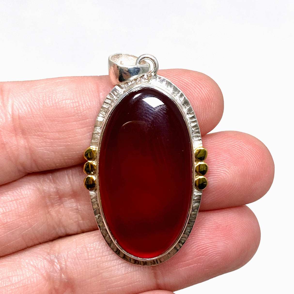 Carnelian Oval pendant with a brass decorative setting KPGJ4581