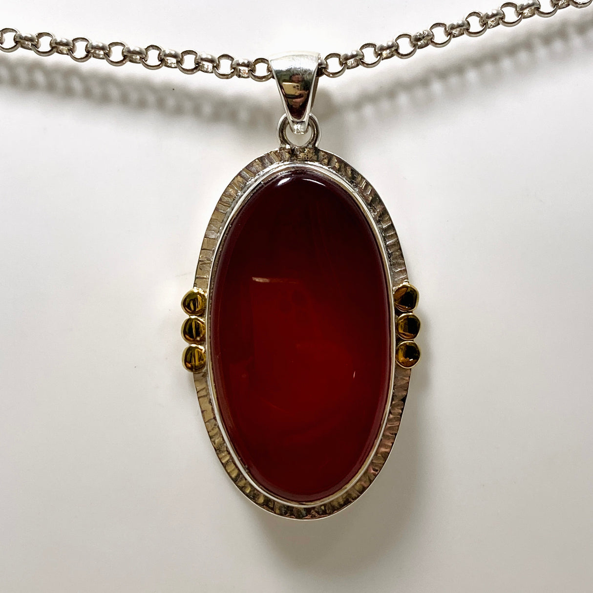 Carnelian Oval pendant with a brass decorative setting KPGJ4581