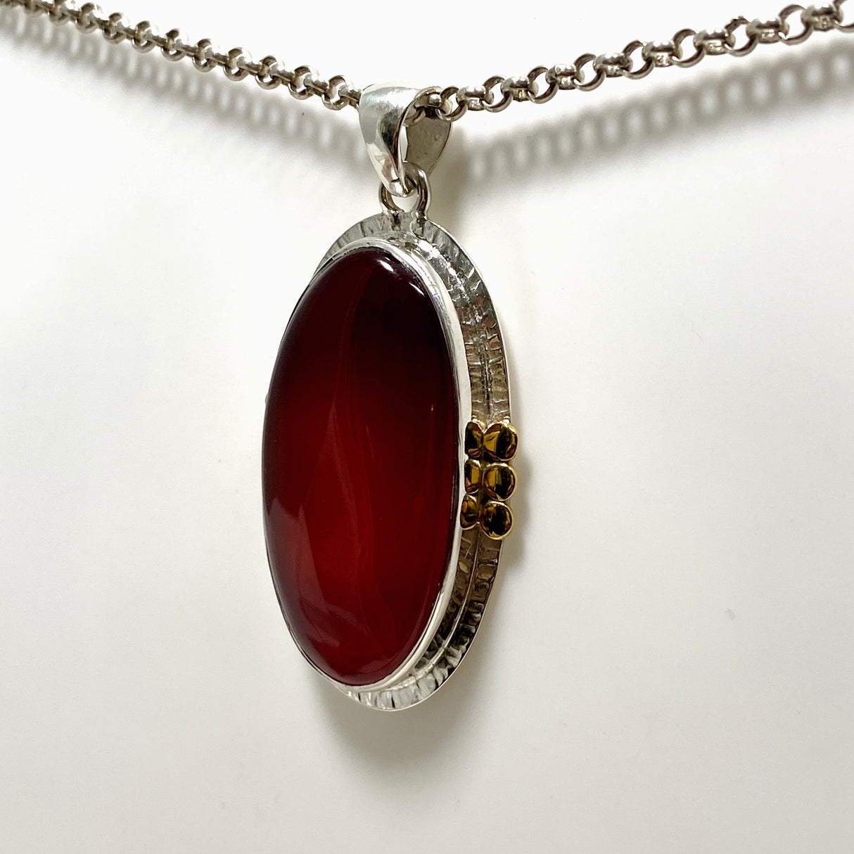 Carnelian Oval pendant with a brass decorative setting KPGJ4581