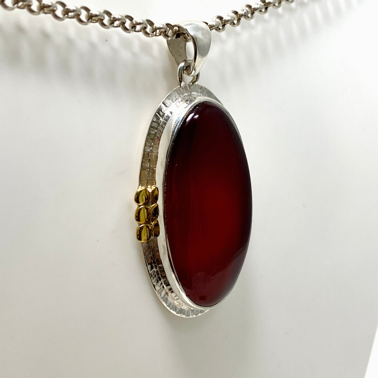 Carnelian Oval pendant with a brass decorative setting KPGJ4581