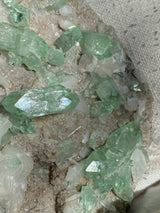 Green crystal-like minerals on a textured surface