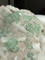 Close up of green apophyllite and white stilbite crystals