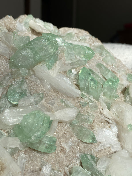 Close up of green apophyllite and white stilbite crystals