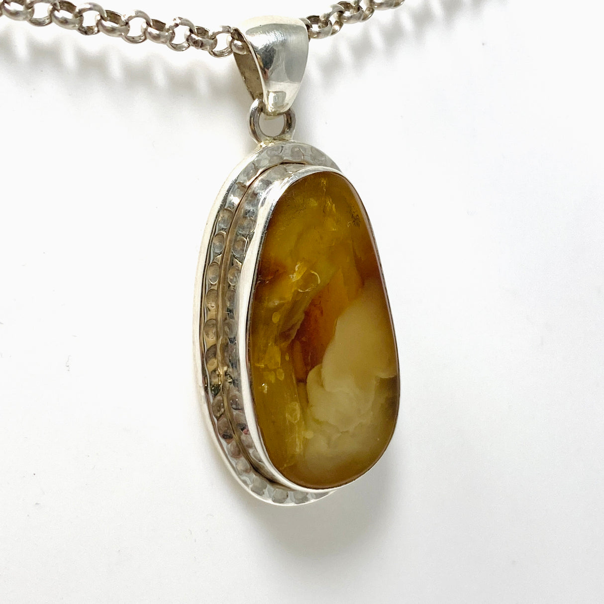 Natural Amber Teardrop Pendant in a Hammered Setting KPGJ4340