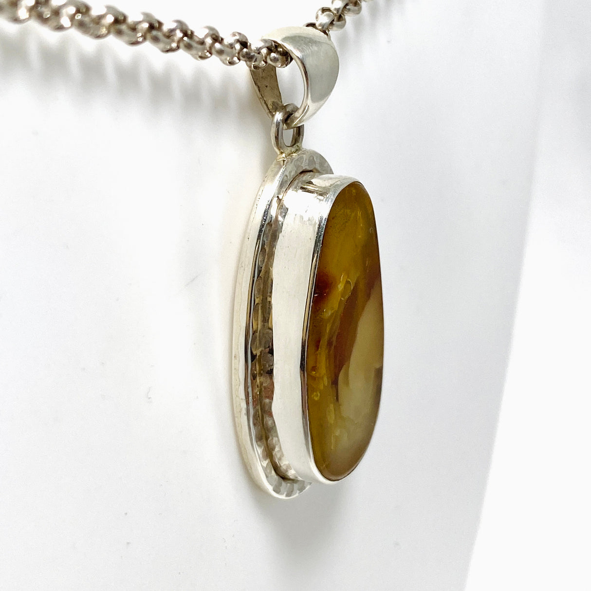 Natural Amber Teardrop Pendant in a Hammered Setting KPGJ4340