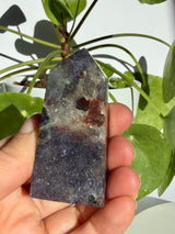 Sunstone in iolite point with a natural crack running down through the upper stone and concentrated sparkle near the base
