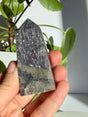 Sunstone in iolite crystal point densely covered in coppery-pink aventurescence sparkle from base to tip