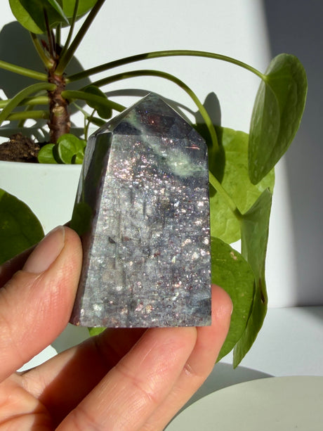 Close view of a sunstone in iolite point showing dense, evenly scattered aventurescence sparkle throughout