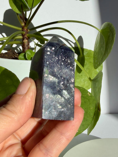 Sunstone in iolite point with fine sparkle running from the upper section down toward a smoky grey base