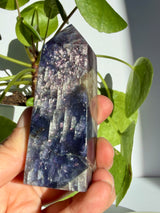Another angle of the sunstone in iolite point, showing the same dense coppery sparkle fading into a deep indigo-black lower section