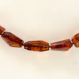 Baltic Amber Cognac beaded necklace on black leather AMB308