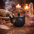 Small kettle-style cast iron cauldron with pentagram design and lid
