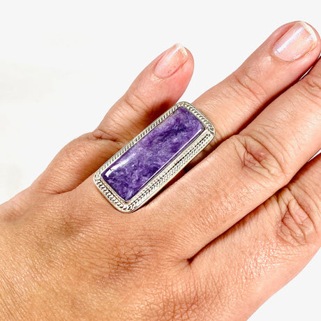 Purple Charoite rectangle ring in sterling silver shown on a hand