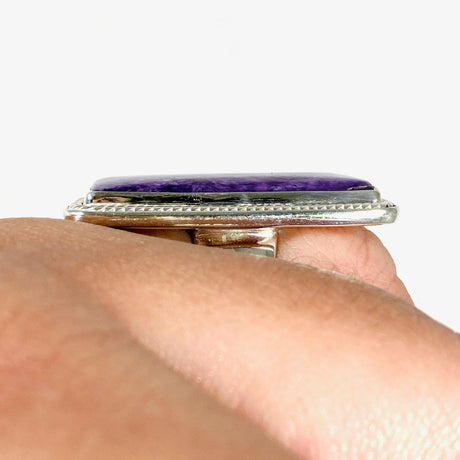 Purple Charoite rectangle ring in sterling silver shown on a hand