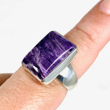 Purple Charoite rectangular ring in sterling silver sitting on a hand
