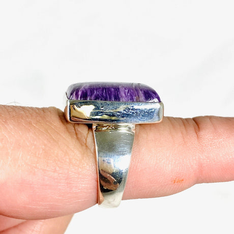 Purple Charoite rectangular ring in sterling silver sitting on a hand