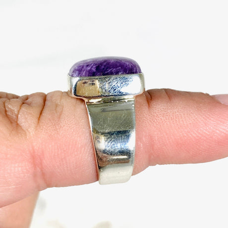 Purple Charoite square ring in sterling silver sitting on a hand