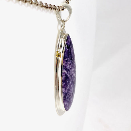 Purple Charoite tear drop pendant with brass detailing  in sterling silver on a chain