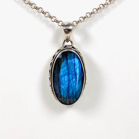 Blue iridescent Labradorite faceted gemstone pendant set in silver on a silver belcher chain