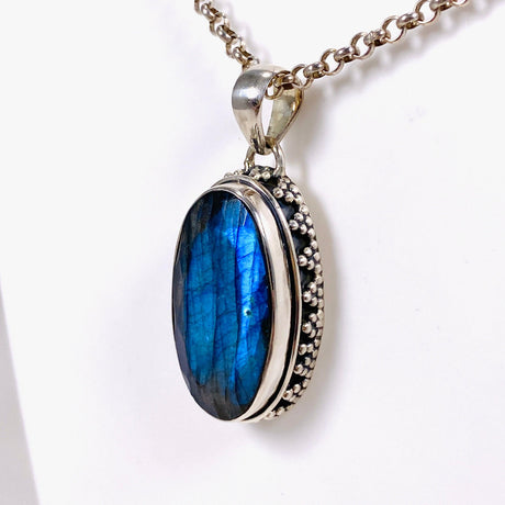 Blue iridescent Labradorite faceted gemstone pendant set in silver on a silver belcher chain