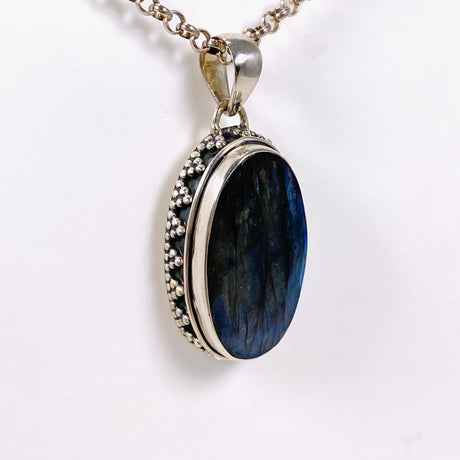 Blue iridescent Labradorite faceted gemstone pendant set in silver on a silver belcher chain