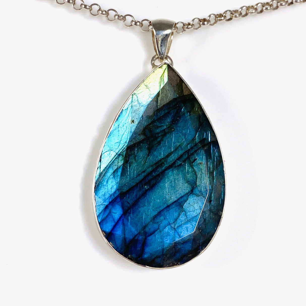 Blue iridescent Labradorite faceted gemstone pendant set in silver on a belcher chain front on angle