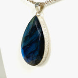 Blue iridescent Labradorite faceted gemstone pendant set in silver on a belcher chain side on angle