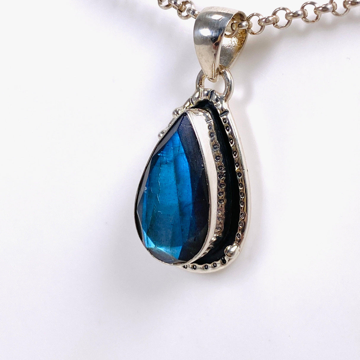 Blue iridescent Labradorite faceted gemstone pendant set in silver on a silver belcher chain