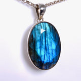 Blue iridescent Labradorite faceted gemstone and silver pendant on a chain