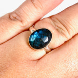 Blue iridescent Labradorite faceted gemstone and silver ring on a hand