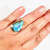 Blue iridescent Labradorite faceted gemstone and silver ring on a hand