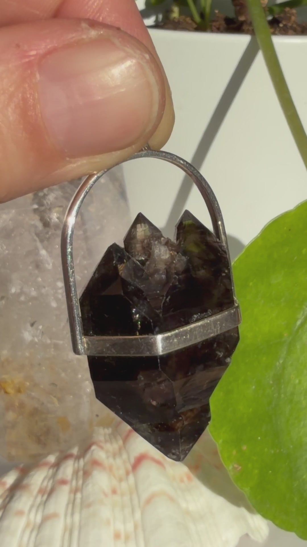 Mooralla Smoky Quartz Pendant held in the sunshine with natural background