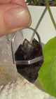Mooralla Smoky Quartz Pendant held in the sunshine with natural background