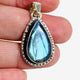 Blue iridescent Labradorite faceted gemstone pendant set in silver shown in the hand