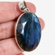 Blue iridescent Labradorite faceted gemstone and silver pendant on live video in a hand